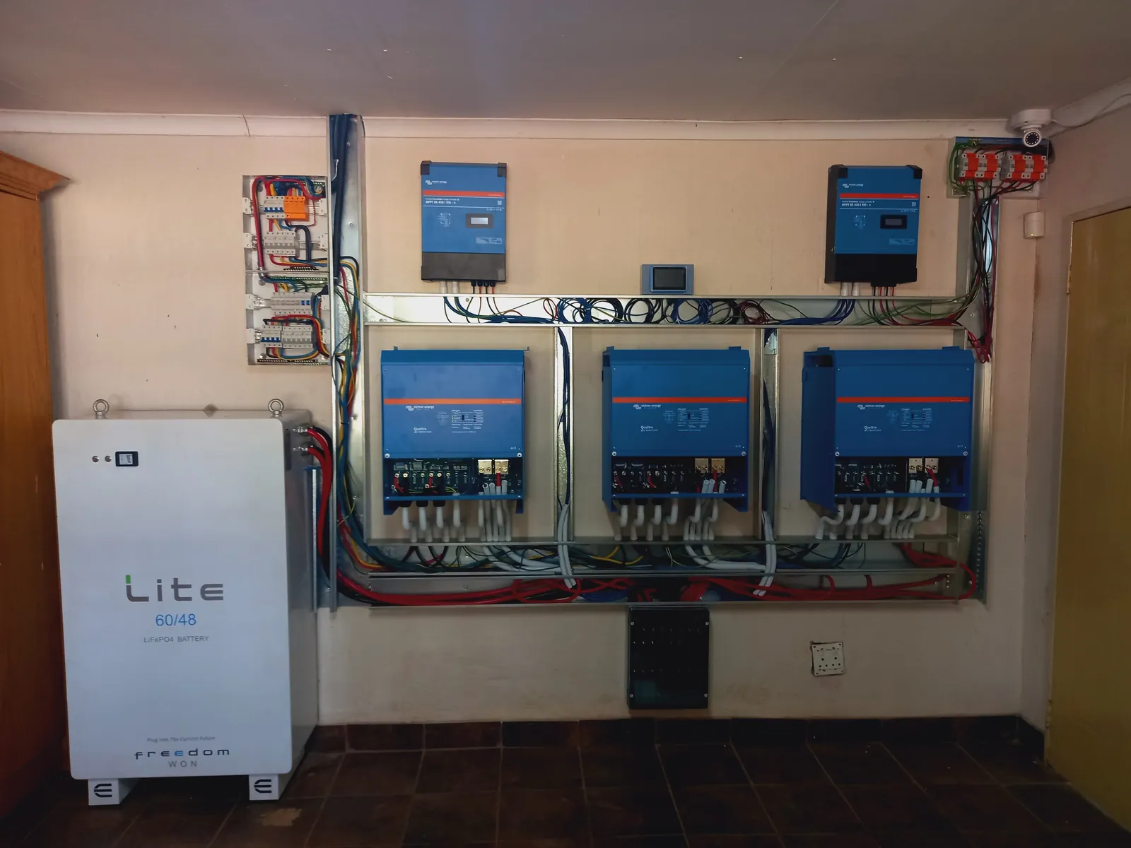 A completed Victron inverter bank with lithium battery storage, neatly mounted and wired